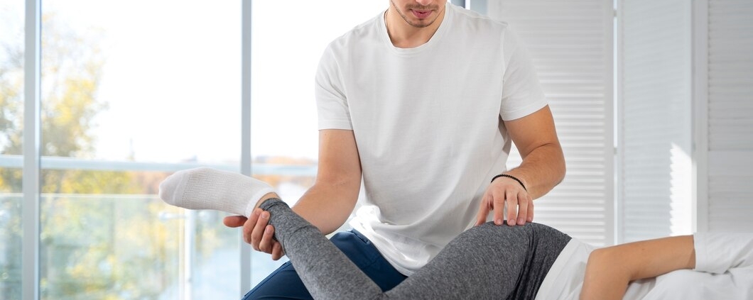 A person receiving sports massage treatment from a professional