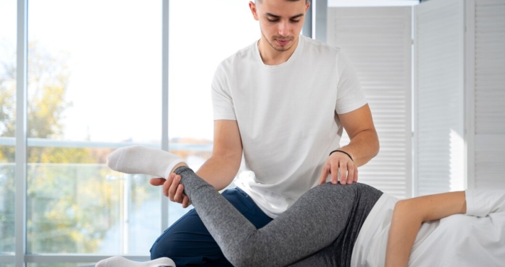 A person receiving sports massage treatment from a professional