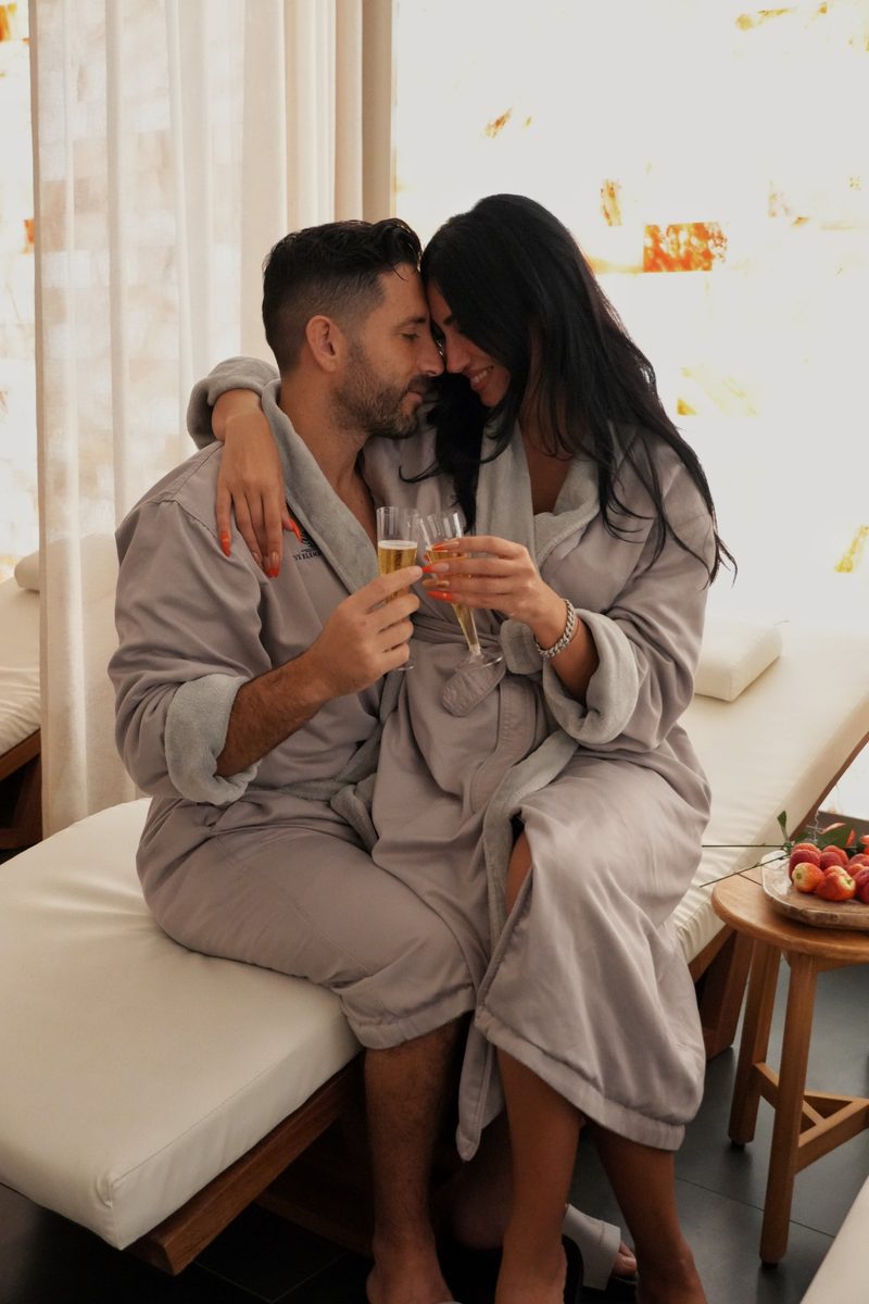 Couple sharing champagne during a spa date night at Five Elements Medical Spa & Wellness Center